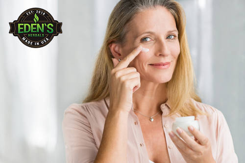 Woman applying CBD lotion to face for better skin care