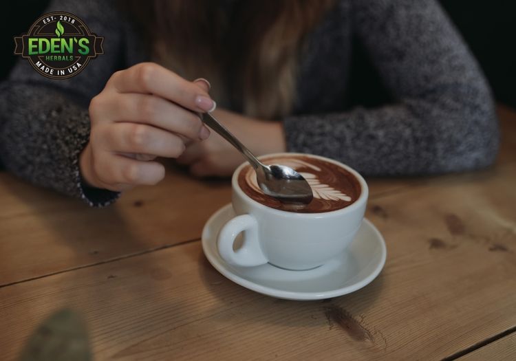woman stirring her cup of cbd coffee at a coffee shop