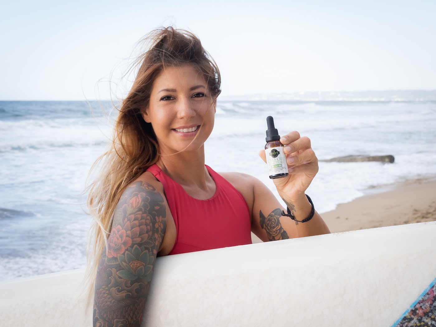 Woman with CBD oil tincture for eczema relief