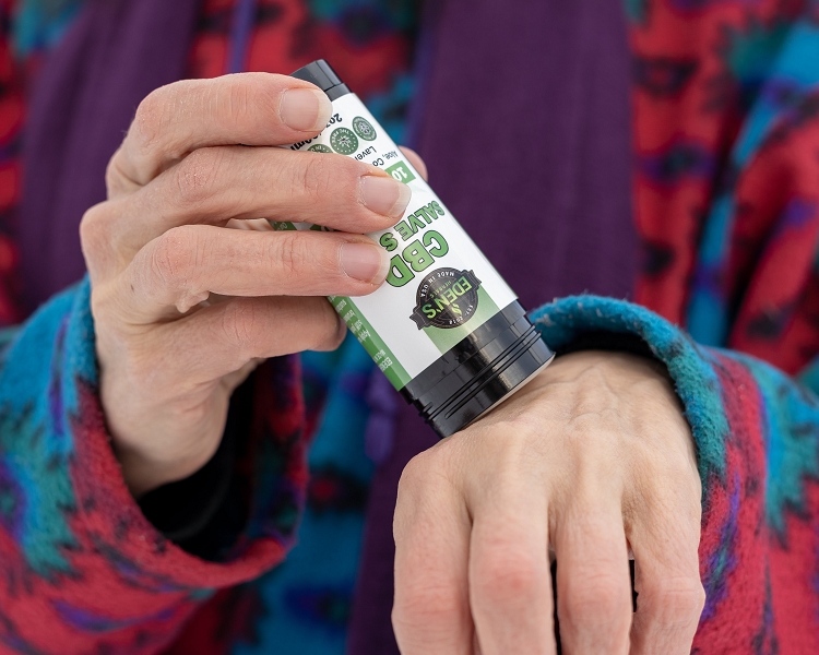 Woman using cbd salve stick for antioxidant and preventing cancer