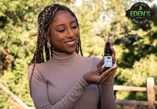 woman holding cbd oil from eden's herbals