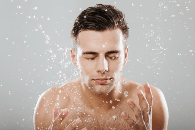 Man cleansing his face to hydrate skin