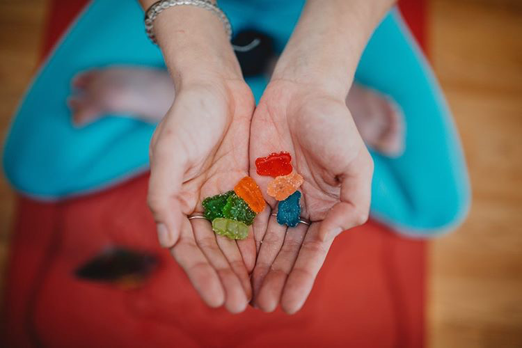 CBD Gummies being offered by two hands