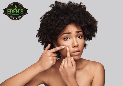 Woman checking acne after using CBD for skin treatment