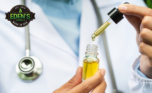 Scientist holding CBD oil tincture