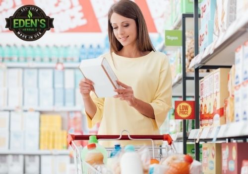 Woman reading labels while shopping for CBD products