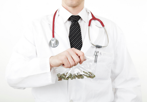 Doctor in lab coat holding up a bag of cbd gummies