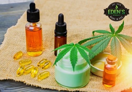 thc and cbd oils on a table with marijuana leaves 