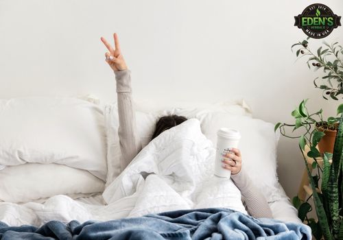 woman laying in bed giving the peace sign with her fingers