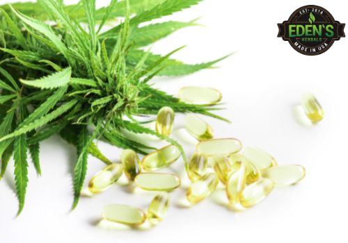 CBD capsules next to a hemp leaf