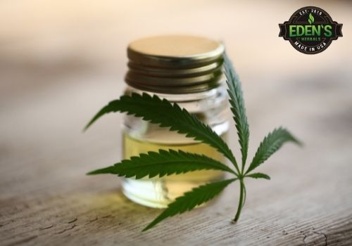 jar of cbd oil with hemp leaf