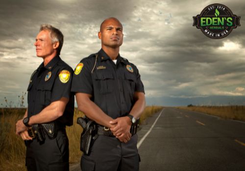 Police officers standing outside by their cruisers