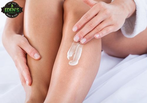 woman applying cbd lotion to legs