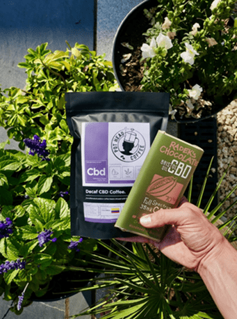 Bag of CBD and bar of CBD infused chocolate bar being held up