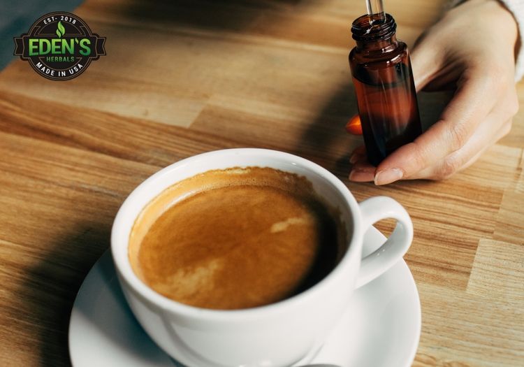 cup of coffee with person adding their cbd oil to it