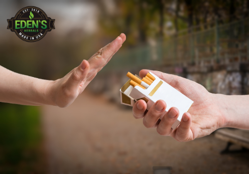 Hand refusing a pack of cigarettes after using cbd for addiction support