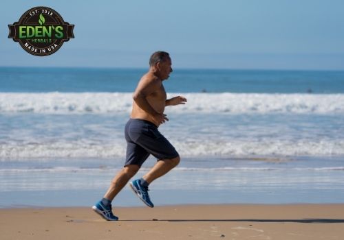 man exercising by taking a run on a beach