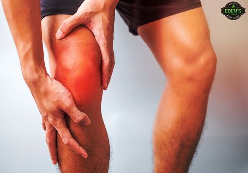 man holding knee that has been highlighted red to show severe muscle pain