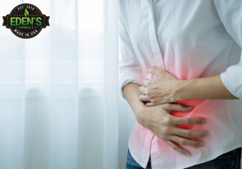woman holding stomach in pain from nausea