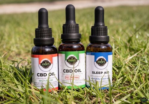 Eden's Herbals CBD oils lined up in the grass