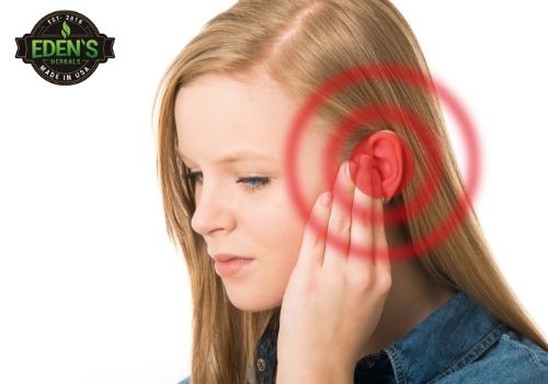 woman holding ear due to tinnitus pain