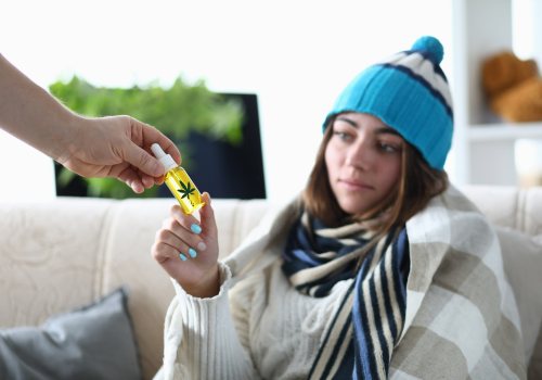 Depressed young woman being handed tincture of cbd oil