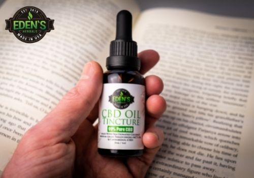 Eden's Herbals CBD oil in front of a book to show how CBD can help with concentration