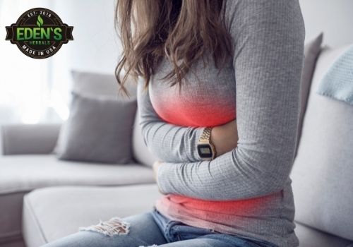 woman holding stomach due to pms symptoms