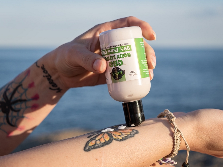 Woman using CBD salve for eczema relief