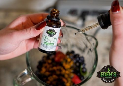 eden's cbd oil being added to a fruit smoothie