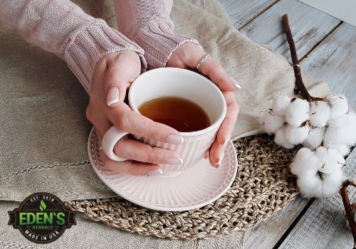 woman holding cup of tea with CBD