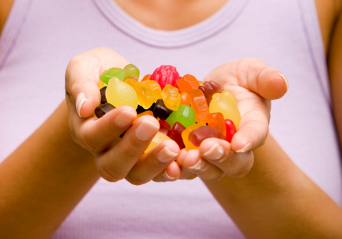 Closeup of womans cupped hands full of cbd gummies