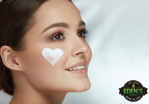 woman with heart of CBD lotion on her cheek
