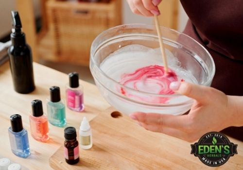 woman mixing bowl of soap with different colors