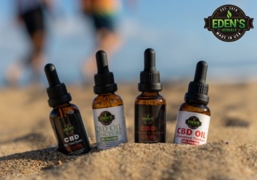 Eden's Herbals CBD Oil Tinctures placed in sand at the beach