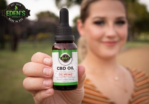 woman holding eden's herbals cbd oil 