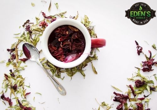 cup of herbal tea with berries and herbs