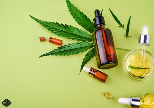 cbd oils next to hemp leaf