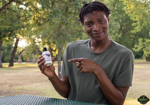 man pointing at eden's herbals cbd lotion