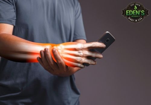 Man holding wrist from pain of carpal tunnel