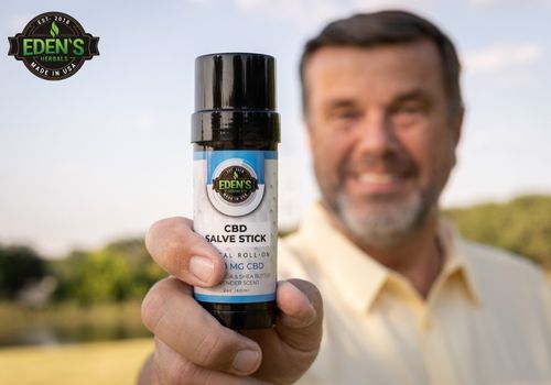 man holding eden's herbals cbd salve stick