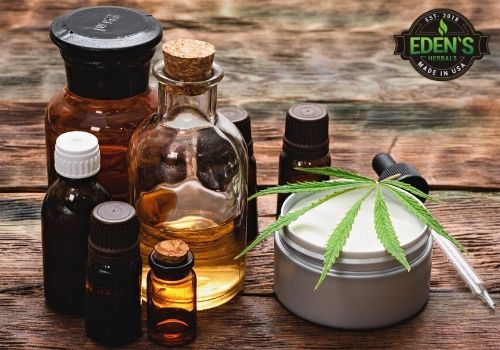 cbd products on a table next to a hemp leaf