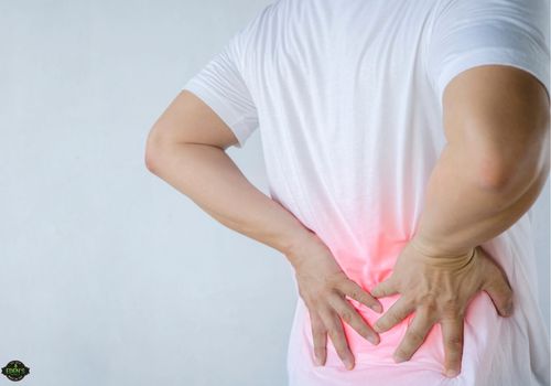 man holding his back that is radiating red to show back pain