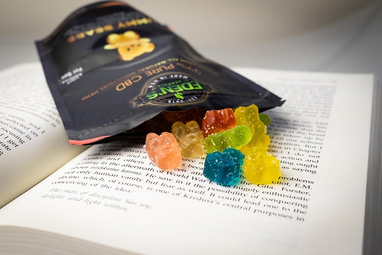 Bag of lab certified CBD gummies on book