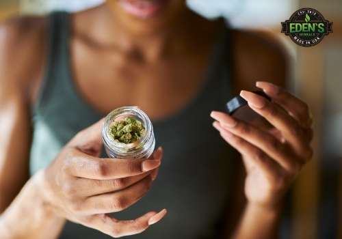 Woman holding jar of marijuana