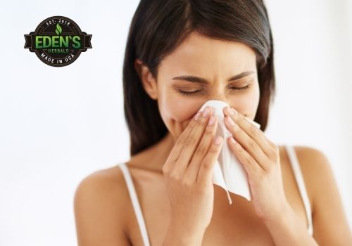 Woman sneezing due to weakened immune system