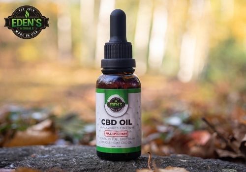 Eden's Herbals CBD oil in a bright green forest